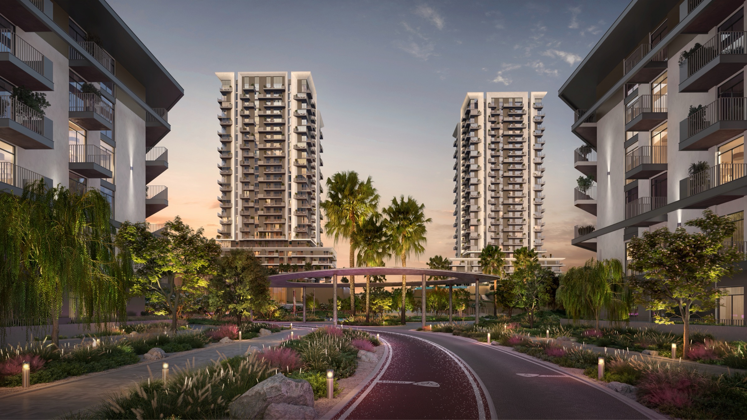 Dusk arrival road with a lit canopy, two pale apartment towers ahead and balcony blocks on either side, a tower render for Azul at Rise by Athlon in Wadi Al Safa 5, Dubailand.