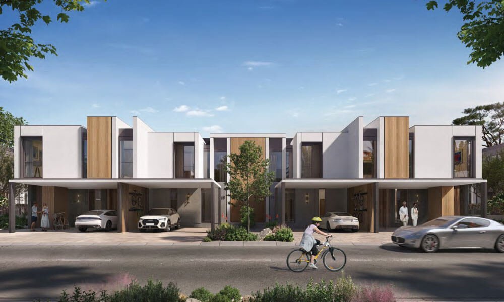 Row of attached homes with timber screens and open carports, and a child cycling past, at Diagon, Athlon in Dubailand.