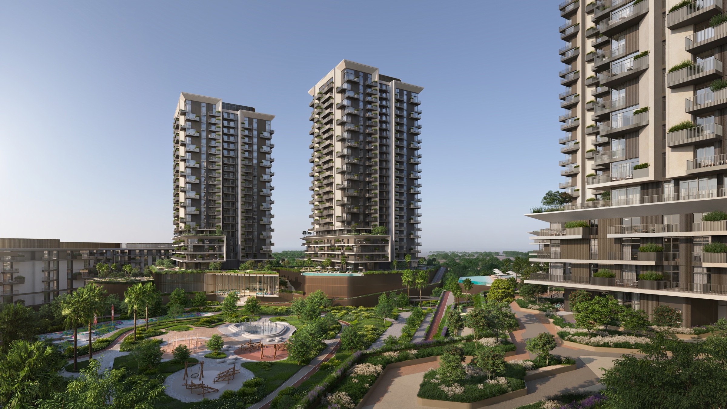 Courtyard with a circular fountain, a playground and winding paths, framed by balcony towers, a building render for Neon at Rise by Athlon in Wadi Al Safa 5, Dubailand. It is not a measured floor plan.