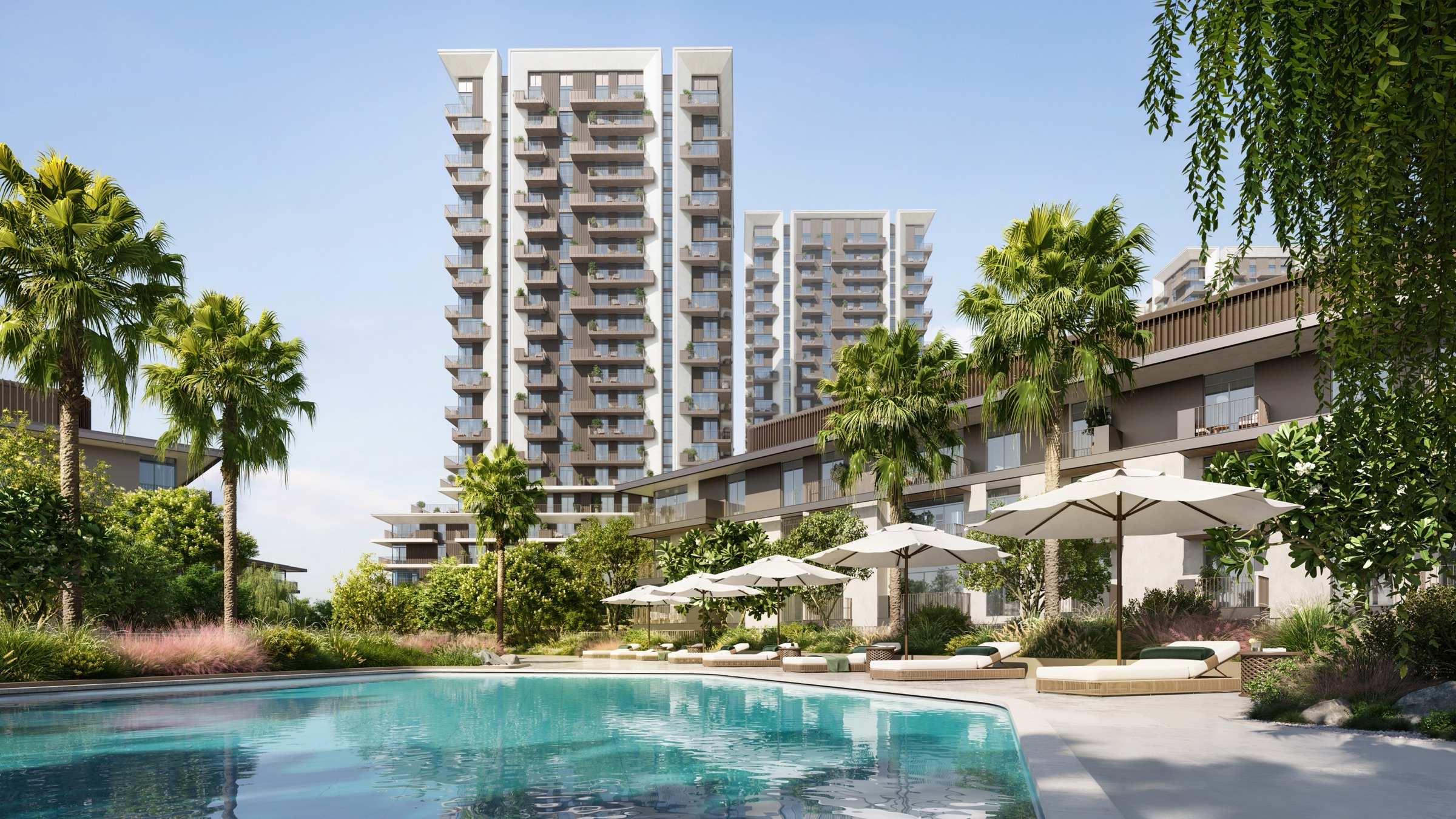 White umbrellas circle a turquoise pool, with two pale towers behind a low wing. Amenity render at Teal, Rise by Athlon, Wadi Al Safa 5, Dubailand.